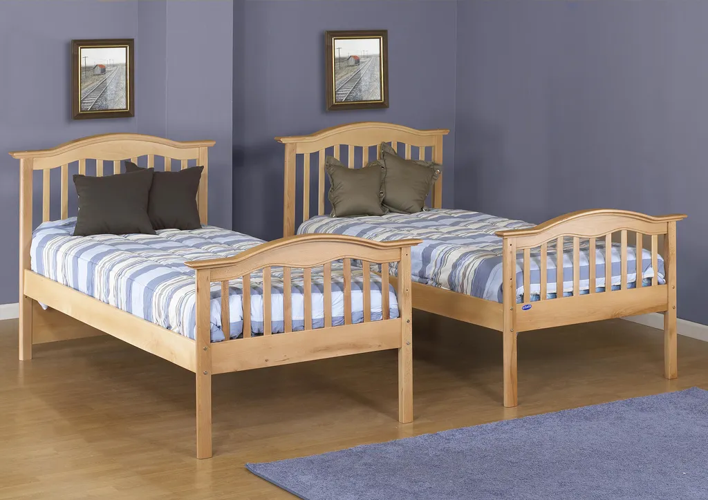 Two wooden twin beds with blue and white striped sheets and pillows.